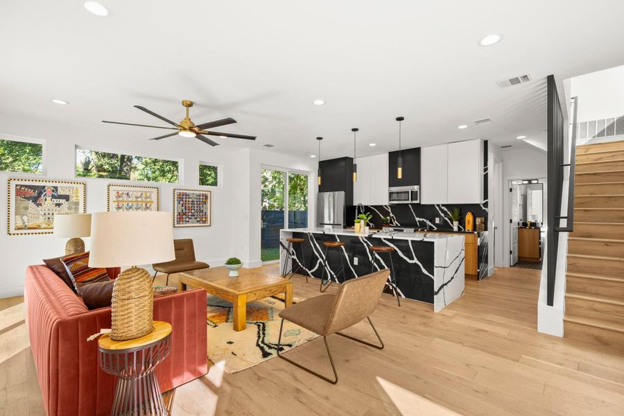 Living area featuring stairs, recessed lighting, light wood finished floors, and a ceiling fan Living area featuring stairs, recessed lighting, light wood finished floors, and a ceiling fan