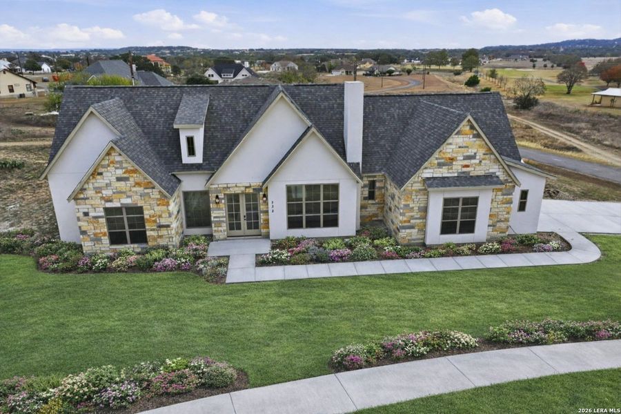 Front exterior of a new home in , Bandera, TX, highlighting curb appeal (Image 27).
