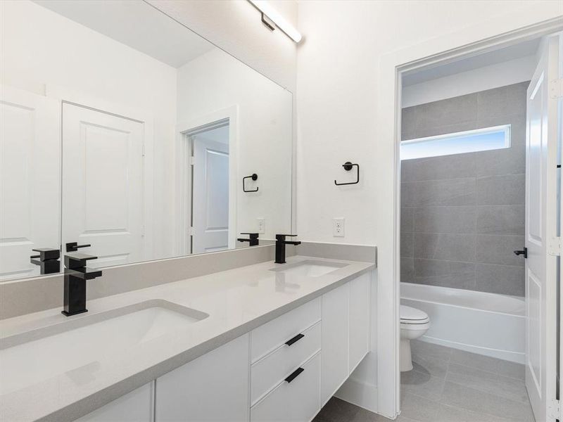 Bathroom featuring light tile patterned floors and washtub / shower combination Bathroom featuring light tile patterned floors and washtub / shower combination