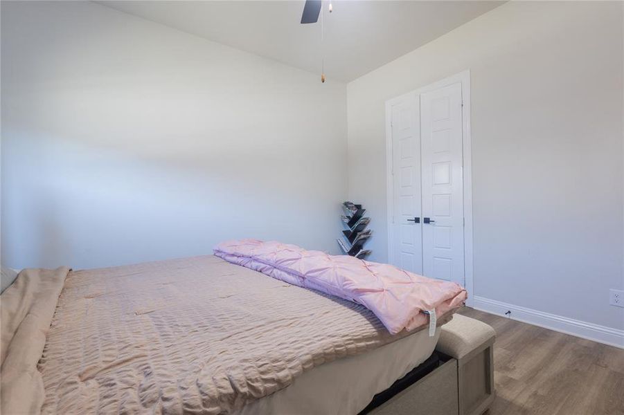 Bedroom with wood finished floors and a ceiling fan