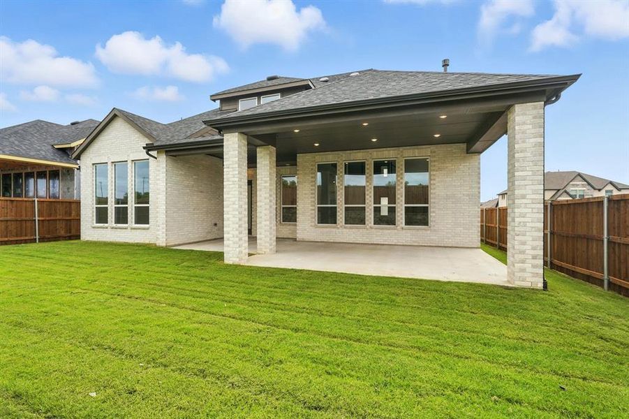 Back of property featuring a patio area, a fenced backyard, brick siding, and roof with shingles Back of property featuring a patio area, a fenced backyard, brick siding, and roof with shingles