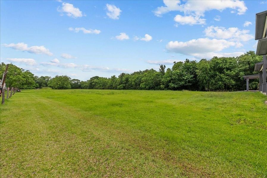 Expansive backyard with endless possibilities for a pool, guest house, or future development.