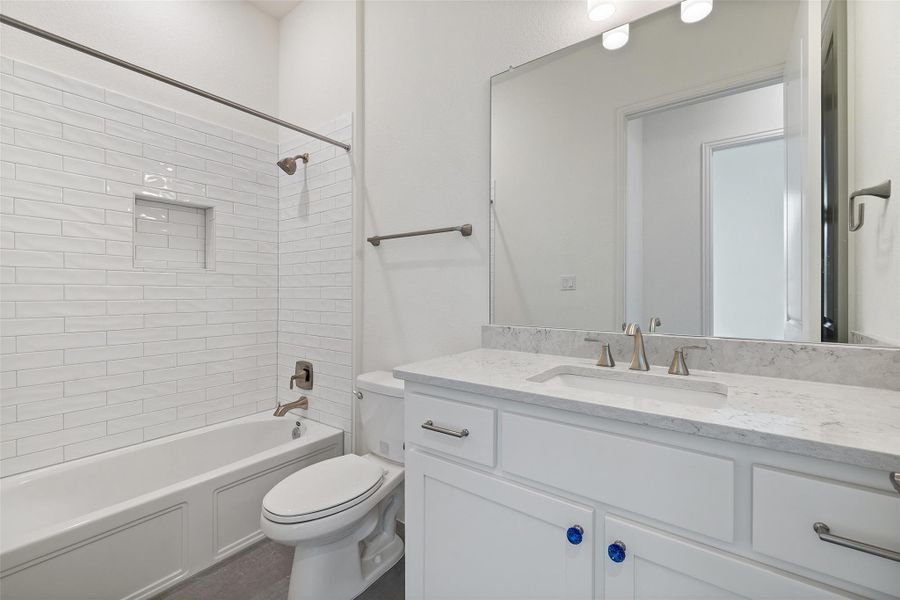 Bathroom featuring toilet, vanity, and shower / bathtub combination