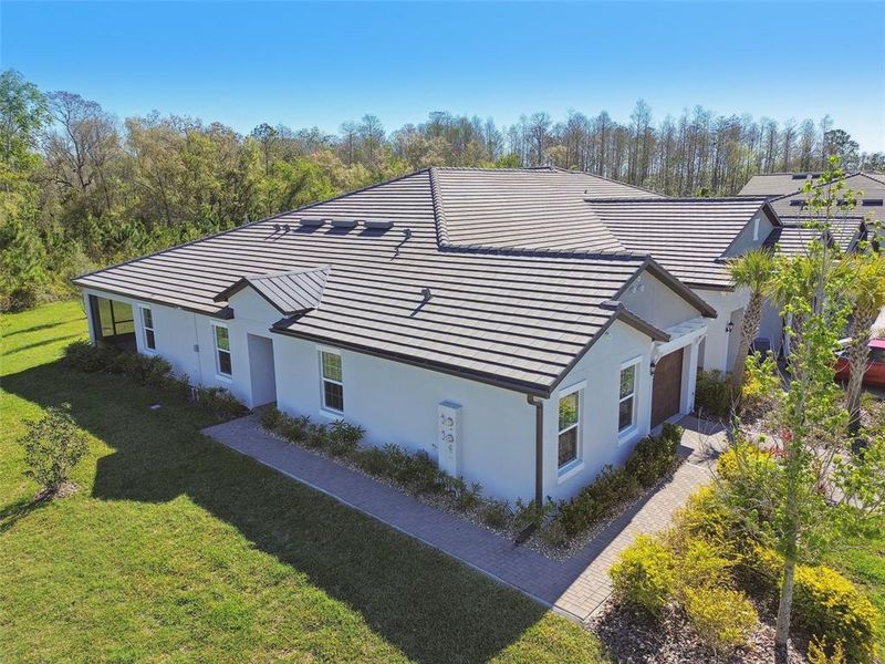Front exterior of a new home in Angeline Active Adult, Land O' Lakes, FL, highlighting curb appeal (Image 24).
