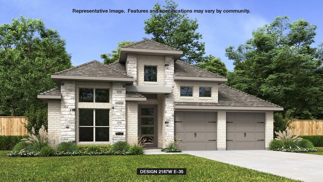 View of front of property featuring a front yard and a garage