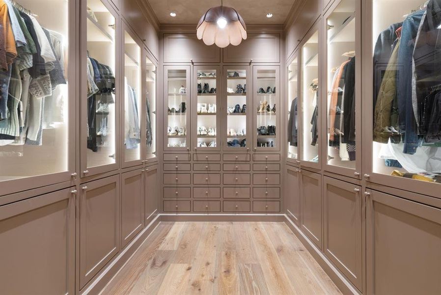 Wine room with light wood finished floors, ornamental molding, and recessed lighting