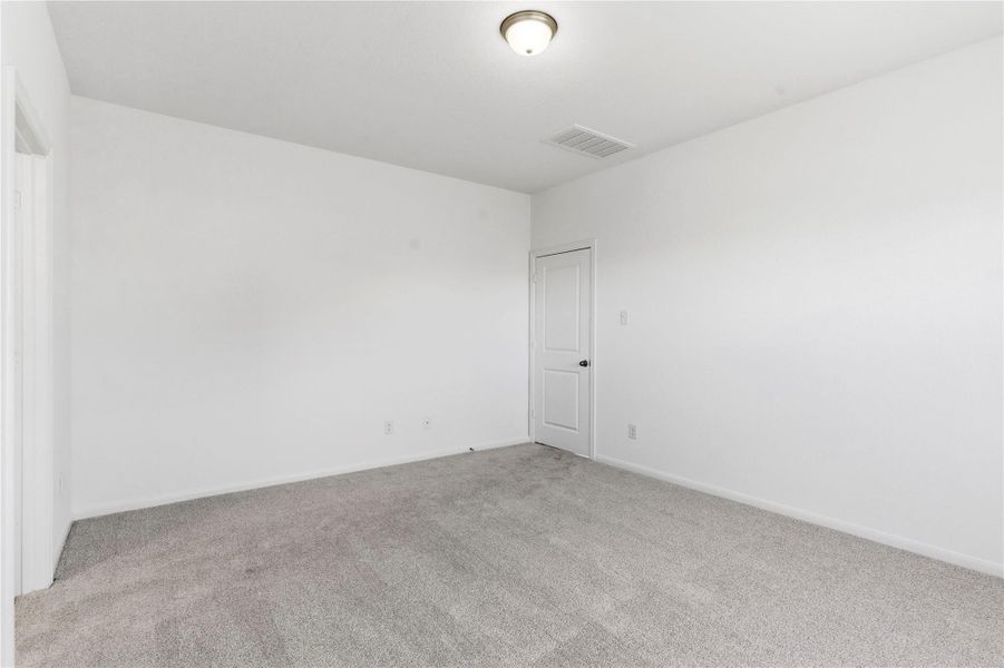 Additional view of the primary suite highlights the generous space, neutral finishes, and comfortable layout. Additional view of the primary suite highlights the generous space, neutral finishes, and comfortable layout.