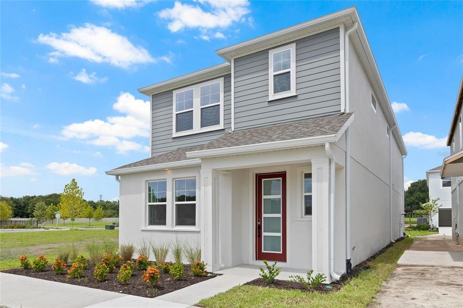 Front exterior of a new home in Vivir, Valrico, FL, highlighting curb appeal (Image 2).