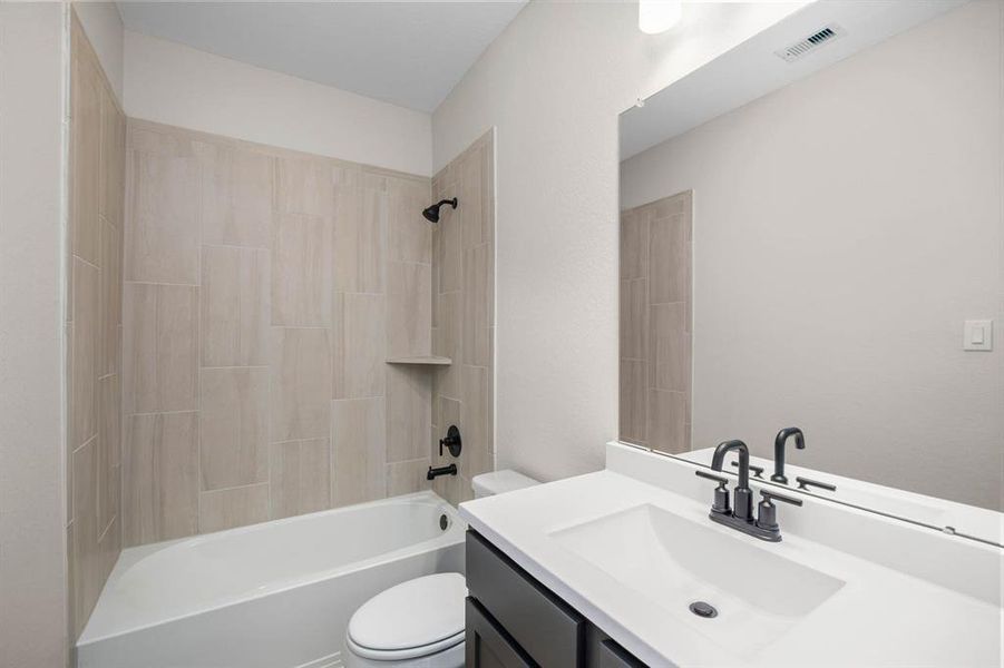 This secondary bathroom has a stylish vanity with lots of storage. The tub-shower combo is very convenient. Whether you're freshening up in the morning or unwinding after a long day, this bathroom is the perfect setting for relaxation and self-care.