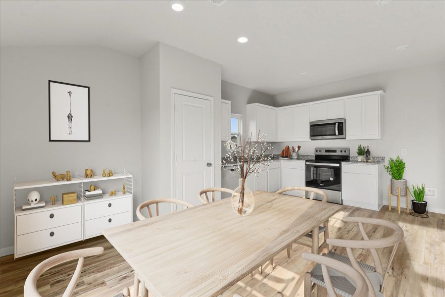 A kitchen with a dining table.