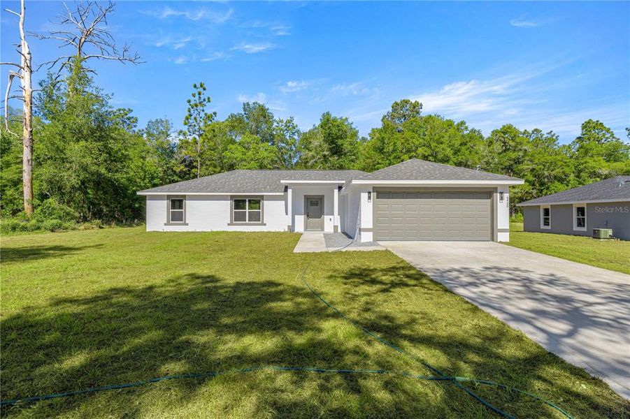 Front exterior of a new home in , Dunnellon, FL, highlighting curb appeal (Image 16).