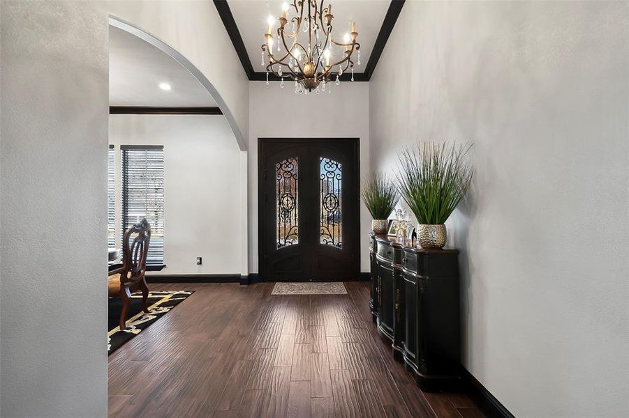 The front entry has a custom made double steel front door. This wood looking tile floor thoughout the entire home.