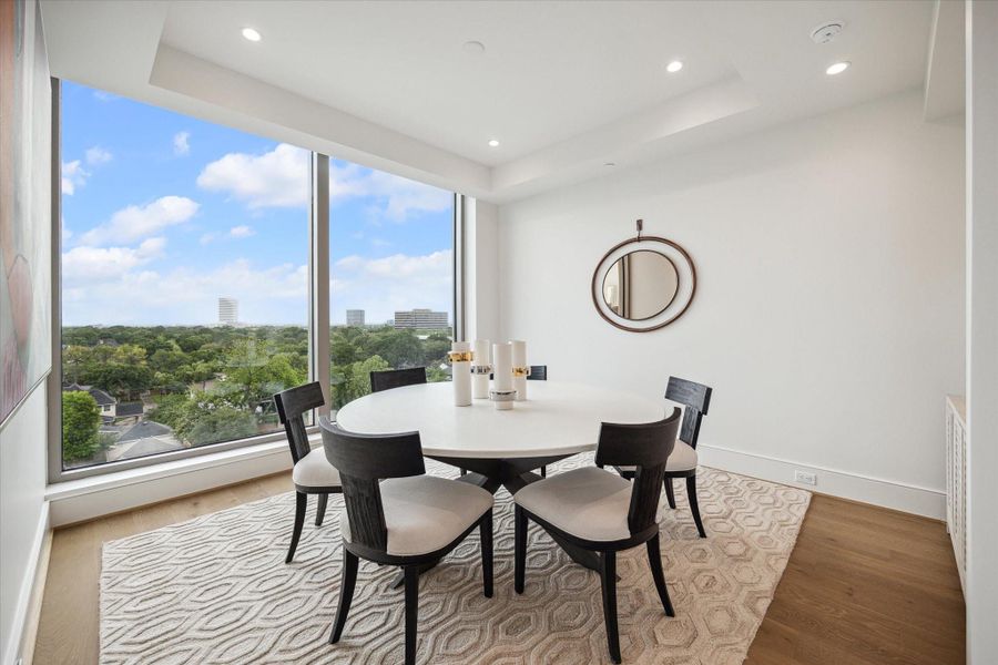 Alternate formal dining view offering a boasting stunning elevated view of lush tree-top.  Photo of a similar unit with same floorplan