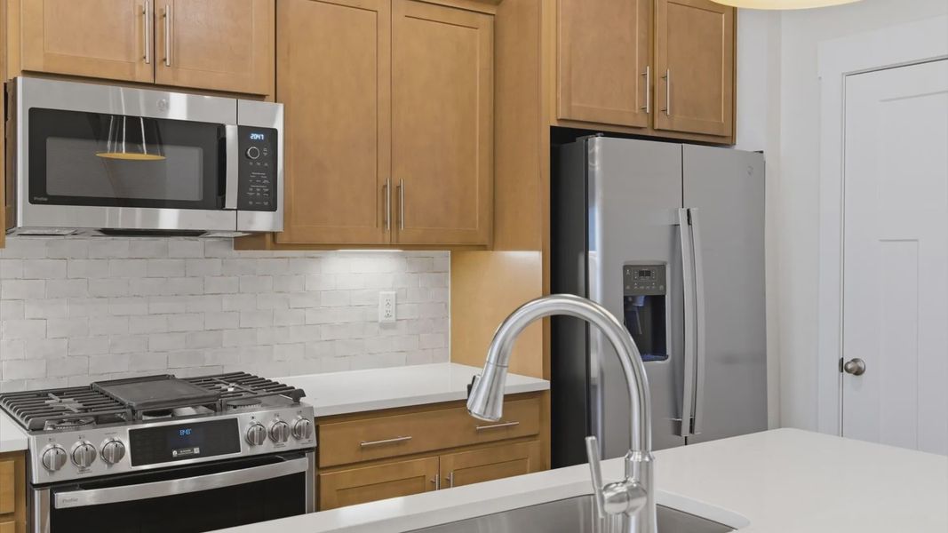 Beautifully appointed kitchen with spacious counters and sophisticated detailing located at the Pelham Crossing community