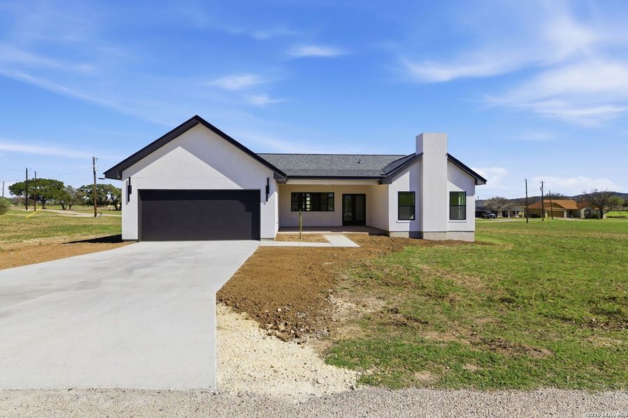 Front exterior of a new home in , Bandera, TX, highlighting curb appeal (Image 28).