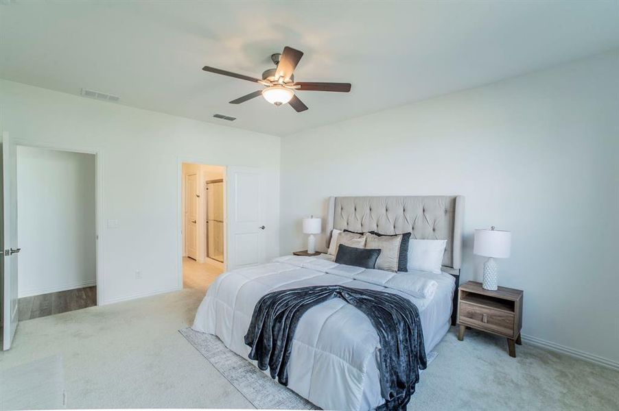 Carpeted bedroom with ceiling fan and baseboards Carpeted bedroom with ceiling fan and baseboards