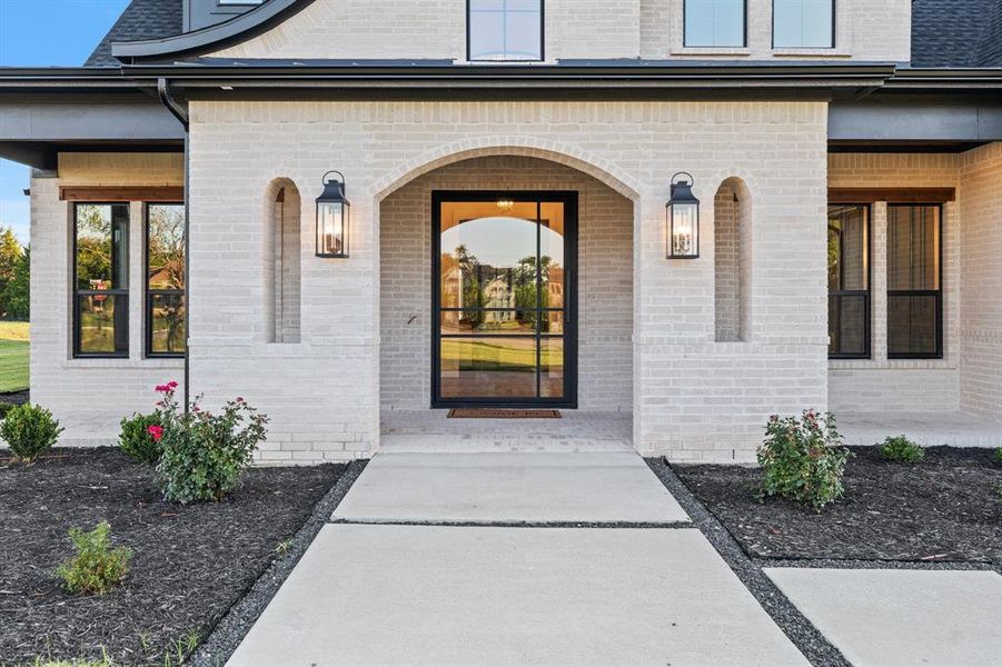 View of exterior entry with a porch