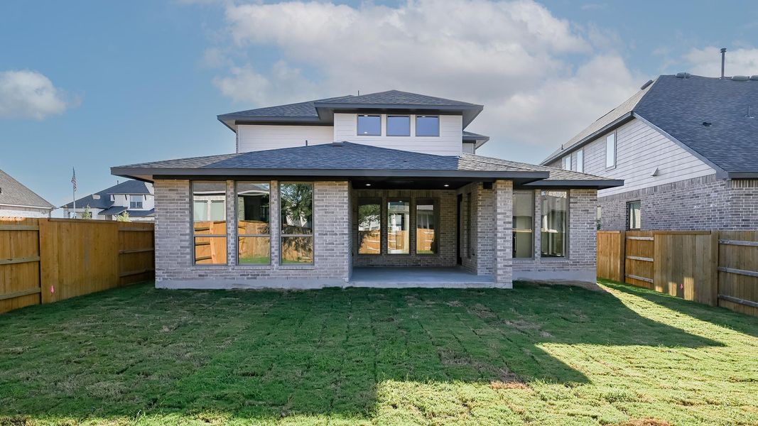 Rear view of property featuring a fenced backyard, a patio, brick siding, and a shingled roof Rear view of property featuring a fenced backyard, a patio, brick siding, and a shingled roof
