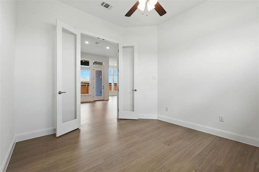 Spare room with dark wood-type flooring, ceiling fan, recessed lighting, and french doors