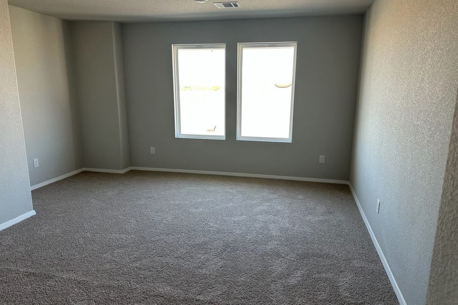 Image of home recreation room with light carpet, white walls, and windows Image of home recreation room with light carpet, white walls, and windows