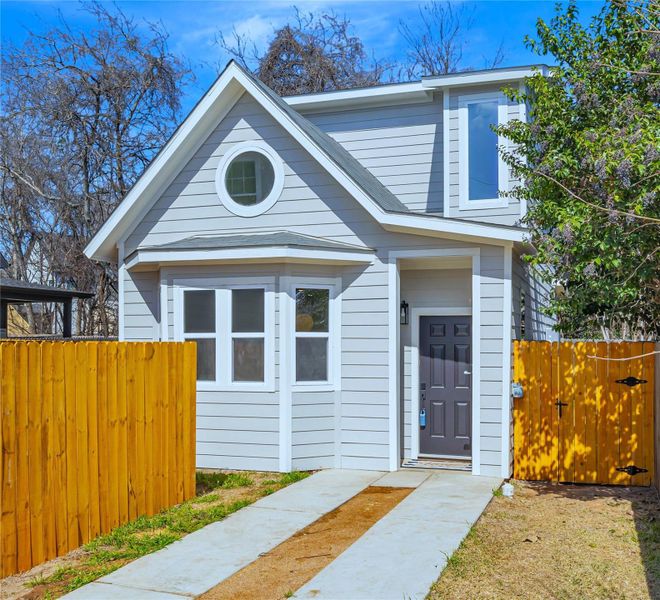 View of front of house with a gate and fence