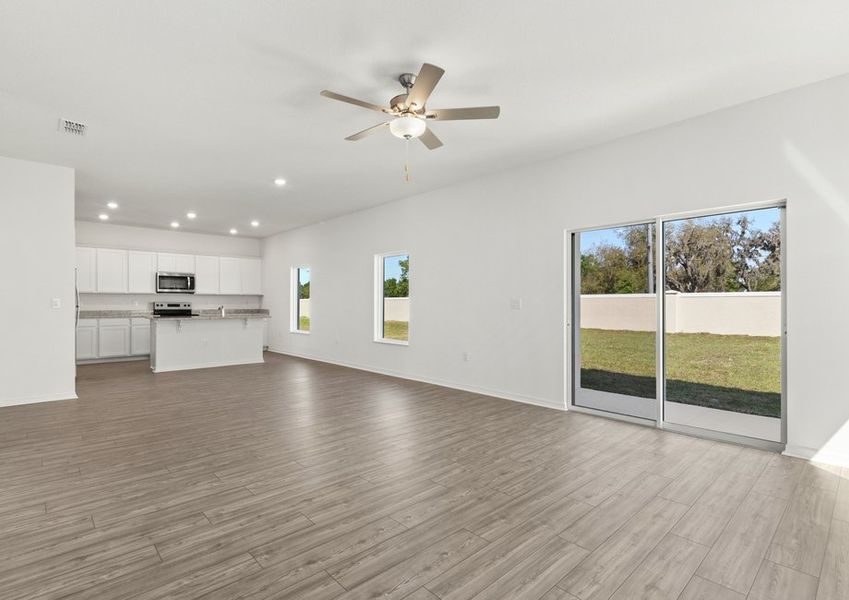 Family room and adjoining kitchen with vinyl flooring