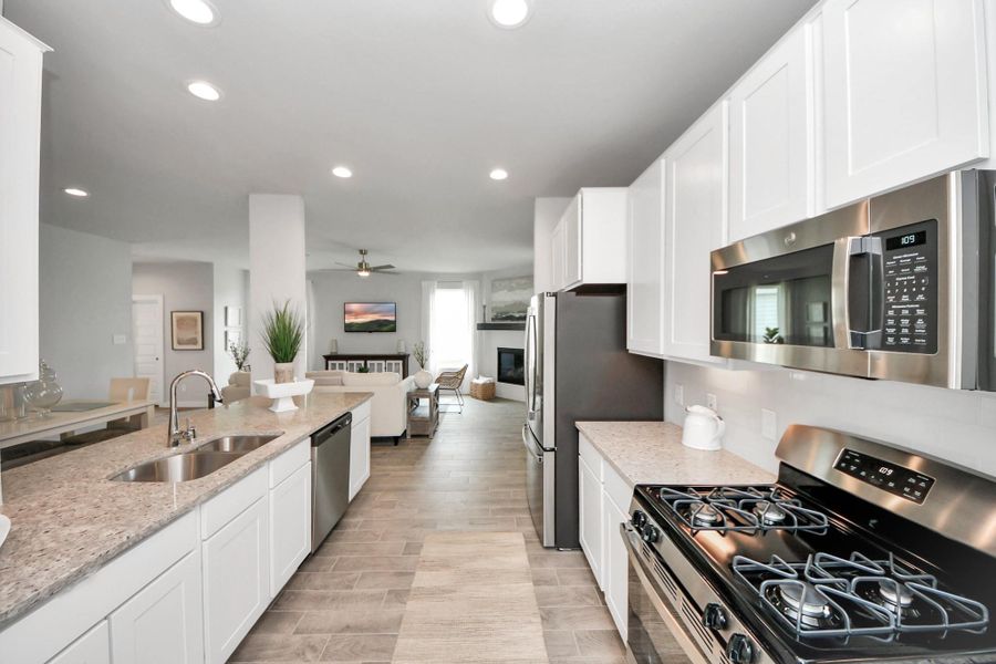 This kitchen is by far any chef’s dream! This spacious kitchen features high ceilings, light stained wood cabinets, granite countertop, SS appliances, modern tile backsplash, recessed lighting, extended counter space, granite kitchen island with double sink, and space for breakfast bar, and a walk-in pantry all overlooking your huge family room. This kitchen is by far any chef’s dream! This spacious kitchen features high ceilings, light stained wood cabinets, granite countertop, SS appliances, modern tile backsplash, recessed lighting, extended counter space, granite kitchen island with double sink, and space for breakfast bar, and a walk-in pantry all overlooking your huge family room.