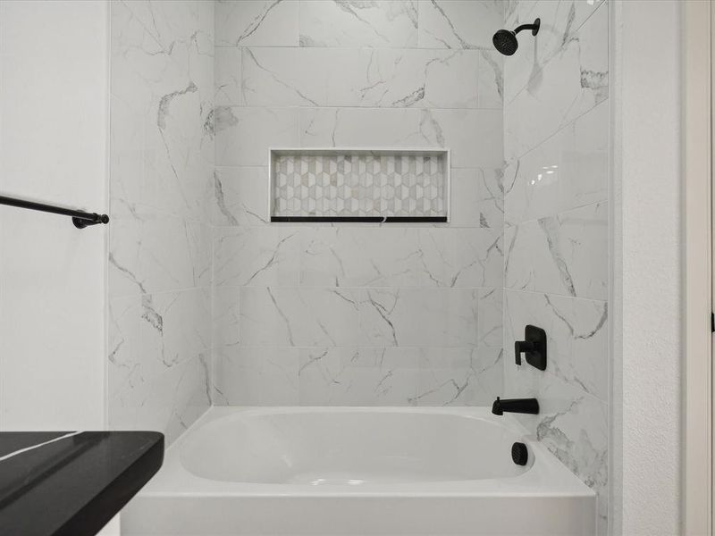 Bathroom featuring tiled shower / bath combo