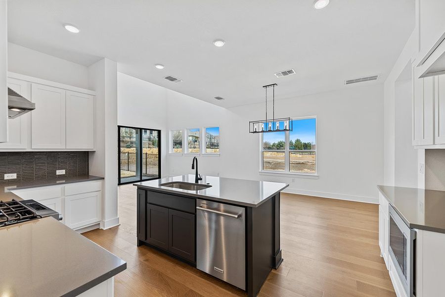 Open floor plan showing kitchen to downstairs living area