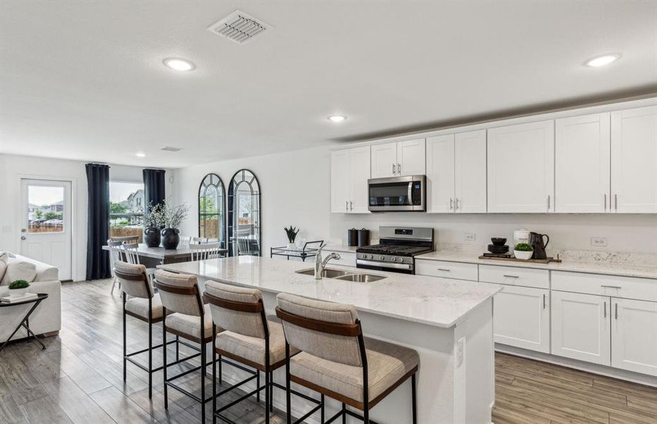 High-end gourmet kitchen with premium finishes and upgraded appliances *Model representation