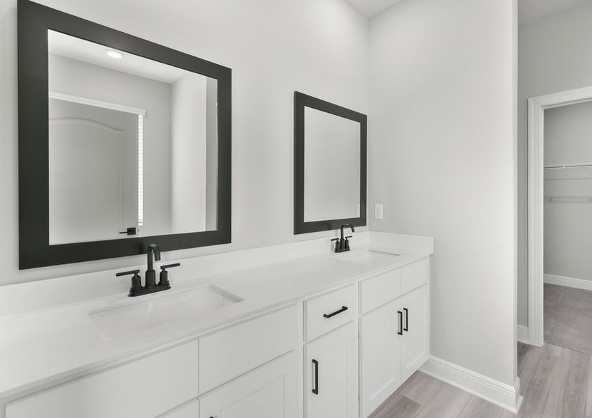 The master bathroom hosts a beautiful dual-sink vanity