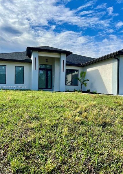 Front exterior of a new home in , Lehigh Acres, FL, highlighting curb appeal (Image 2). Front exterior of a new home in , Lehigh Acres, FL, highlighting curb appeal (Image 2).