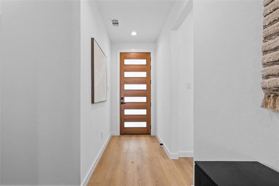 Doorway featuring wood finished floors and recessed lighting Doorway featuring wood finished floors and recessed lighting