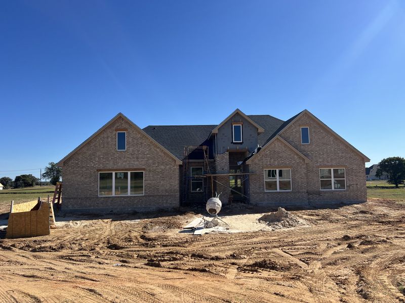 Front exterior of a new home in Zion Valley, Poolville, TX, highlighting curb appeal (Image 1).
