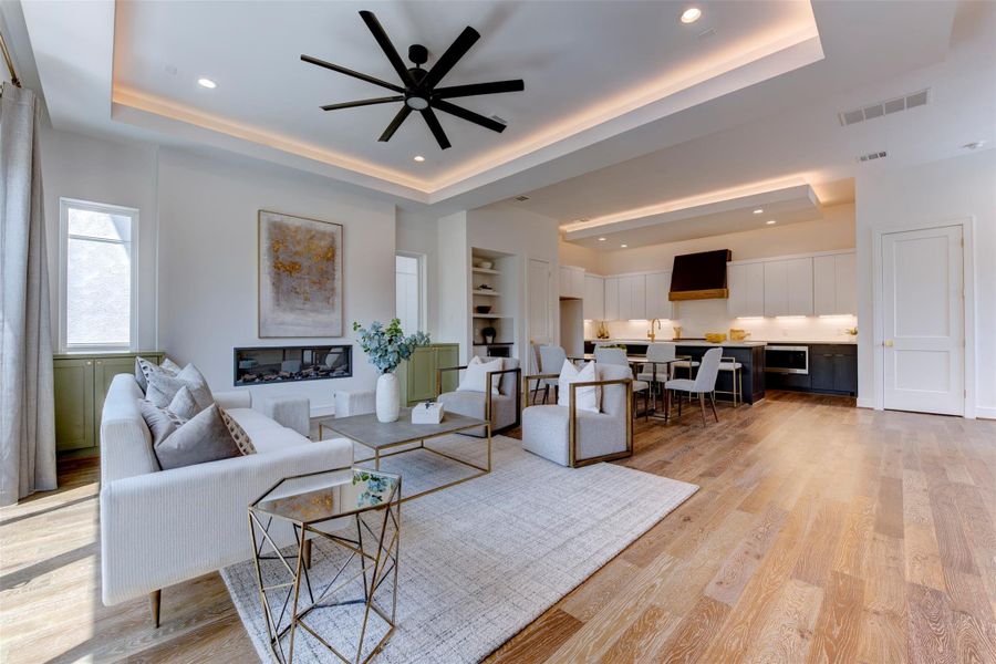 Another view showcasing the spacious living area, highlighting the open concept design and abundant natural light streaming in.