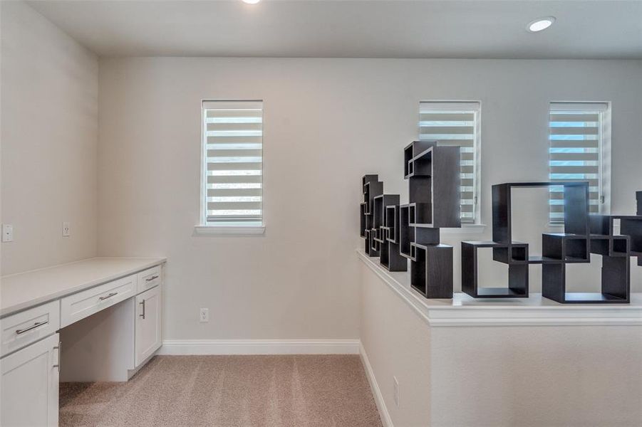 Unfurnished office featuring light carpet, built in study area, and recessed lighting Unfurnished office featuring light carpet, built in study area, and recessed lighting