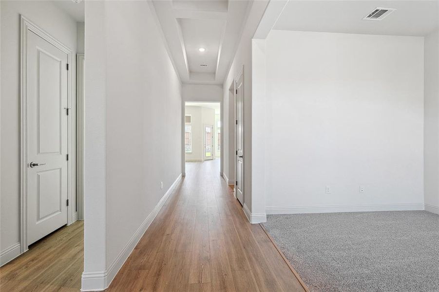 Hall featuring light wood-type flooring, recessed lighting, and beam ceiling