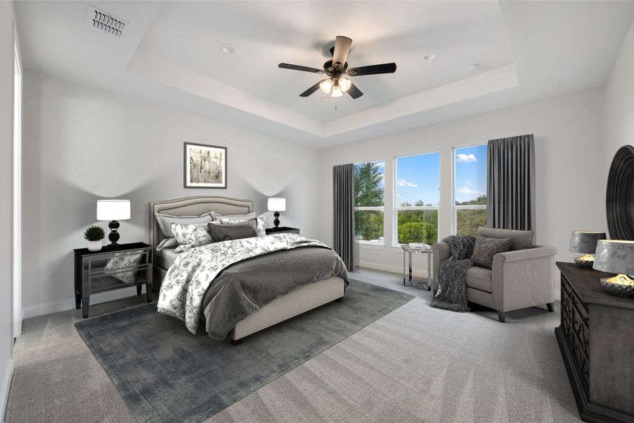 Bedroom with a ceiling fan and light carpet