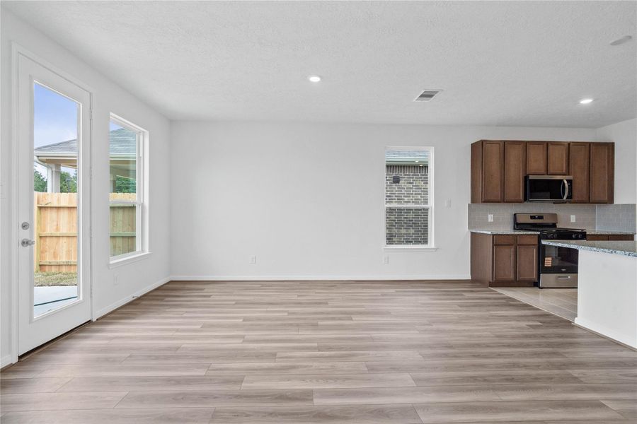 Create lasting memories around the table with family and friends in this inviting dining room! It showcases high ceilings, large windows with privacy blinds, and recessed lighting, and access door to the back patio and yard. Create lasting memories around the table with family and friends in this inviting dining room! It showcases high ceilings, large windows with privacy blinds, and recessed lighting, and access door to the back patio and yard.