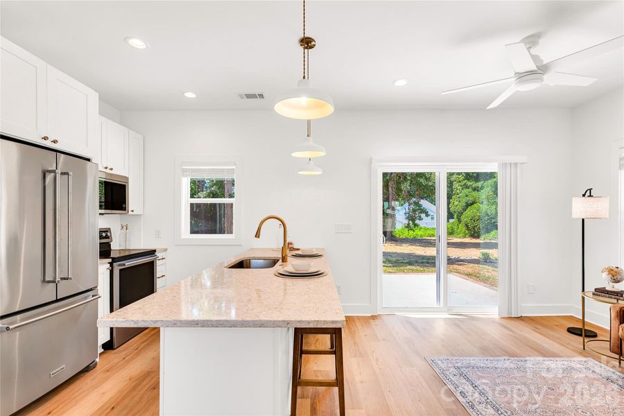 Open floor plan with large island and large sliding glass doors