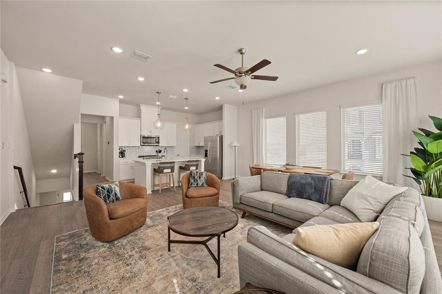 Living room with ceiling fan and light wood-type flooring