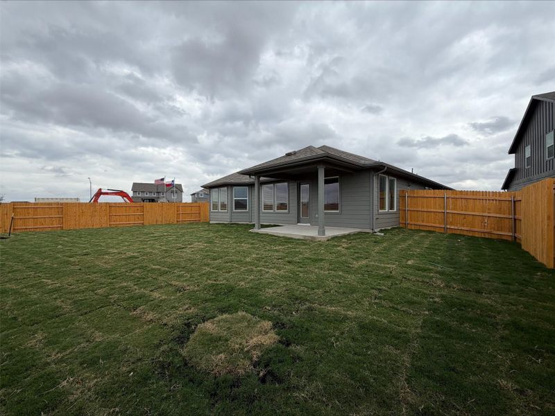Rear view of property featuring a patio area and a fenced backyard