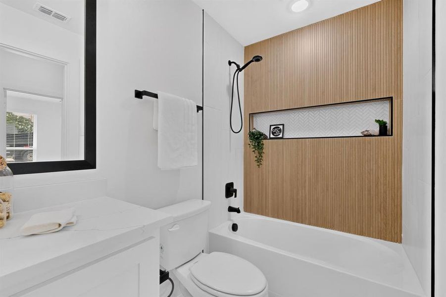 Full bathroom featuring a tub/shower combination with a fluted wood-finish accent wall