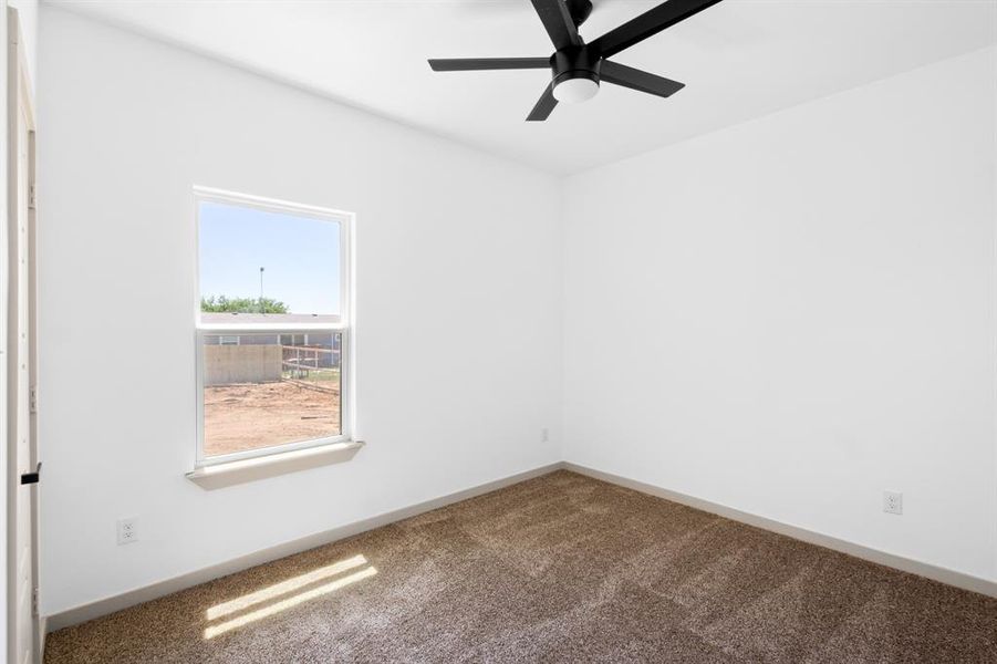 Unfurnished room featuring baseboards, a ceiling fan, and carpet flooring Unfurnished room featuring baseboards, a ceiling fan, and carpet flooring