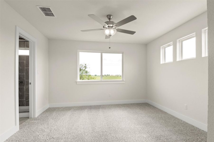 Empty room featuring visible vents, carpet, ceiling fan, and baseboards