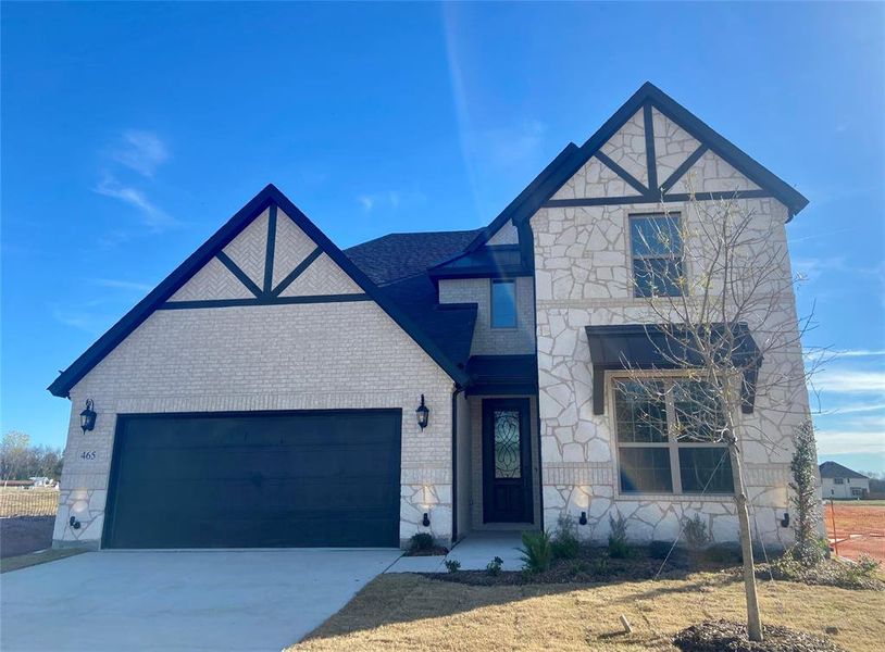Gorgeous new home with white brick, white stone, and cedar & metal roofs accents. Gorgeous new home with white brick, white stone, and cedar & metal roofs accents.