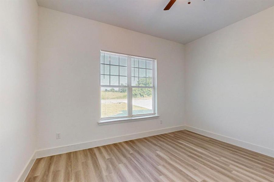 Unfurnished room featuring light hardwood / wood-style floors and ceiling fan