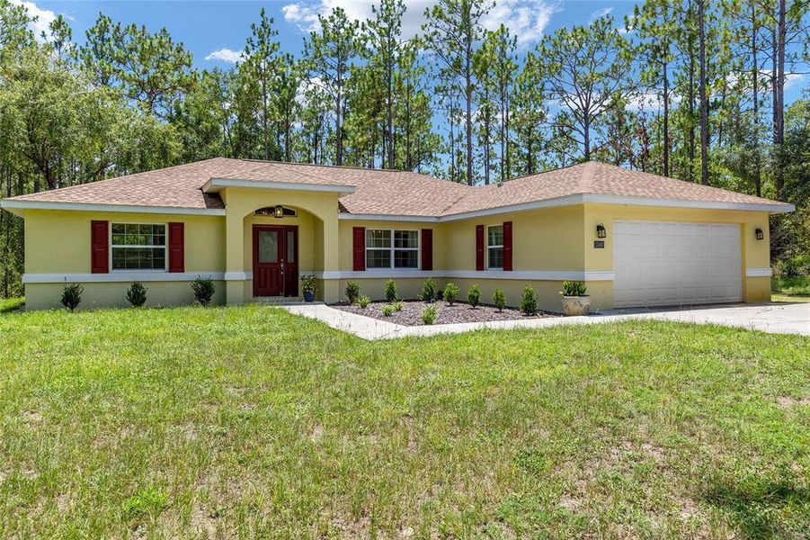 Front exterior of a new home in Rainbow Springs, Dunnellon, FL, highlighting curb appeal (Image 21).