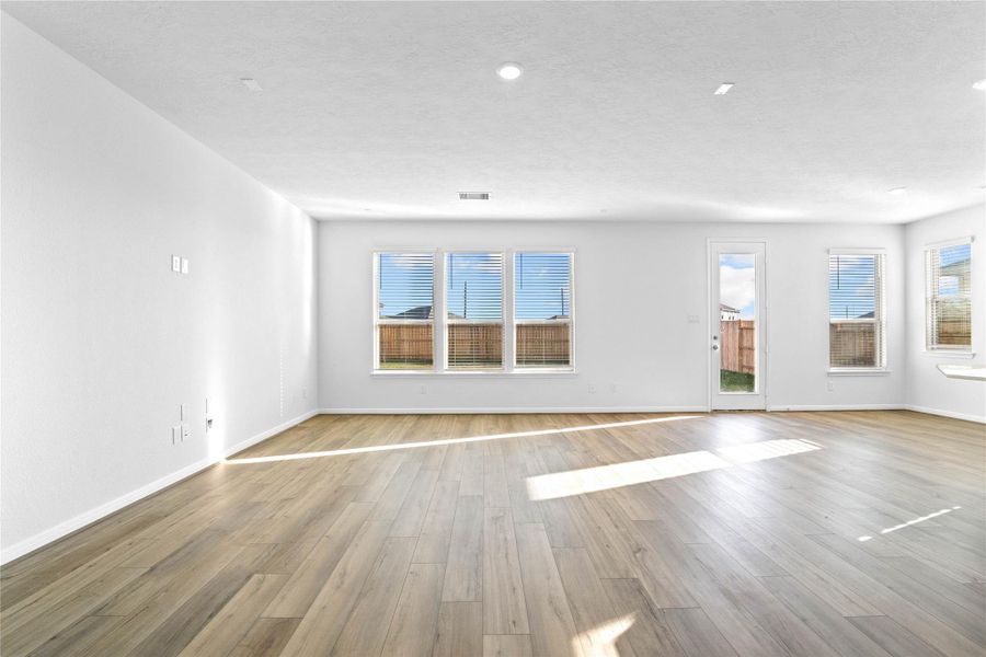 This bright and airy Great Room offers a spacious layout ideal for both relaxing evenings and lively gatherings. Designed for comfort and connection, it features Layton Lake vinyl plank flooring in Driftwood, large windows with blinds, soaring ceilings, recessed lighting, and seamless access to the stunning kitchen—perfect for everyday living and entertaining alike. This bright and airy Great Room offers a spacious layout ideal for both relaxing evenings and lively gatherings. Designed for comfort and connection, it features Layton Lake vinyl plank flooring in Driftwood, large windows with blinds, soaring ceilings, recessed lighting, and seamless access to the stunning kitchen—perfect for everyday living and entertaining alike.