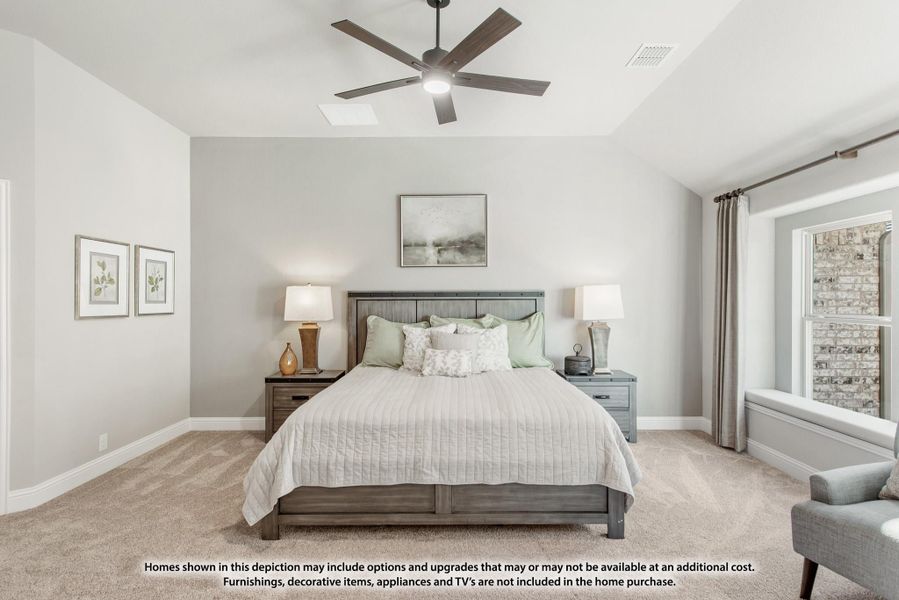 Bedroom with vaulted ceiling, ceiling fan, wood bed frame, carpet floors, and two nightstands with lamps